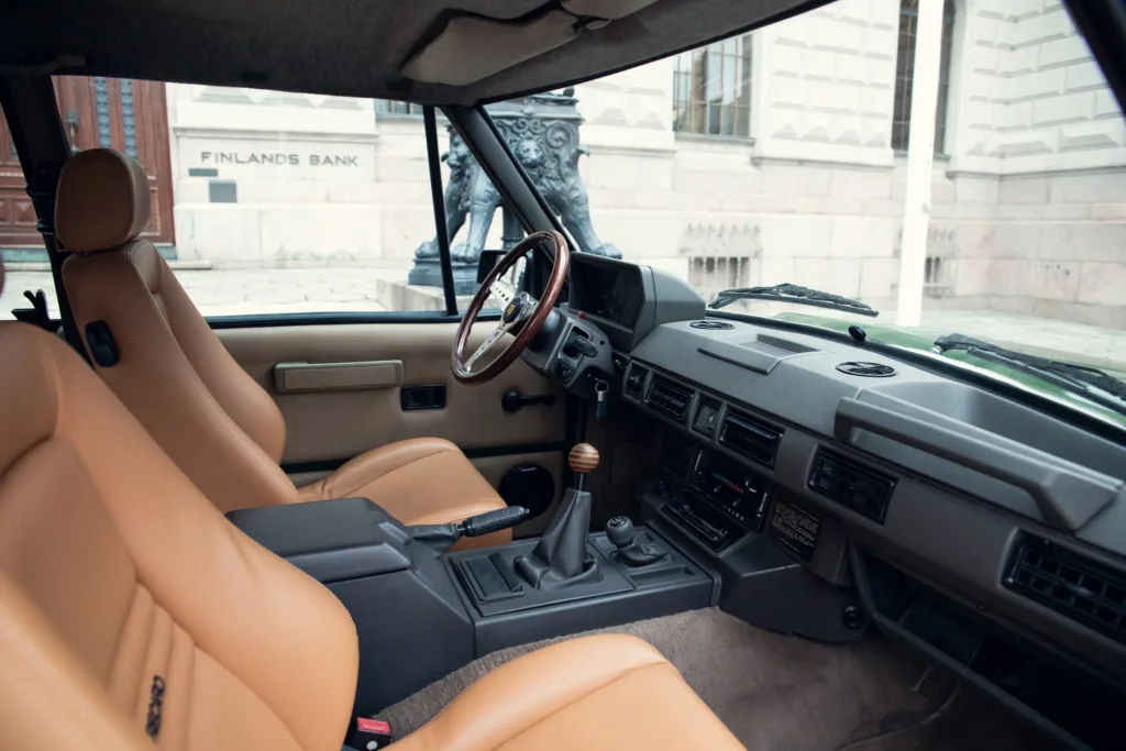 Vintage car interior with tan leather seats.