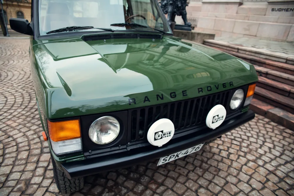 Green Range Rover classic car front view.