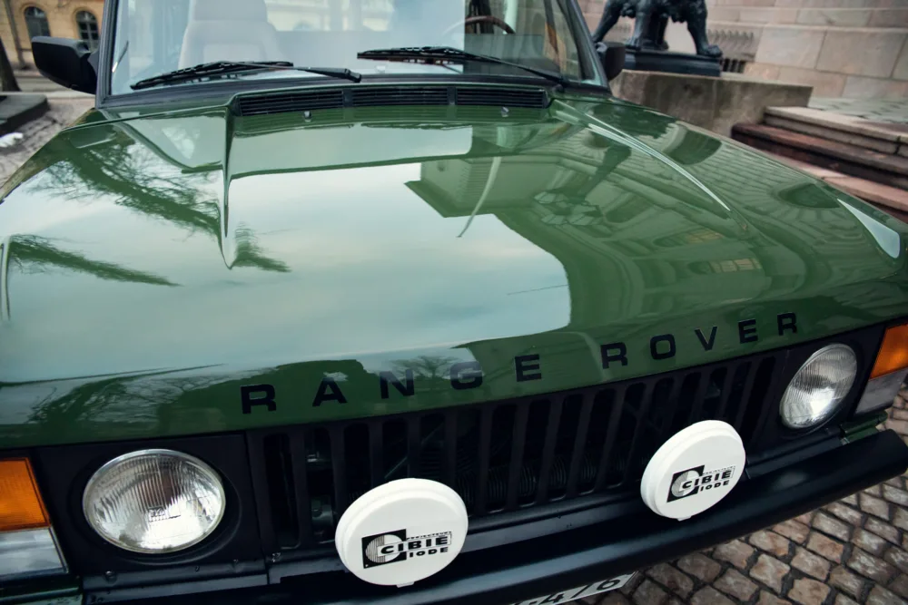 Close-up of a classic green Range Rover front.
