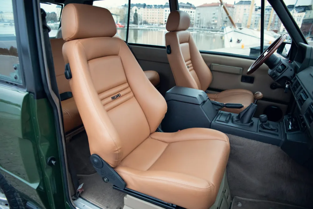 Classic car interior with tan leather seats.