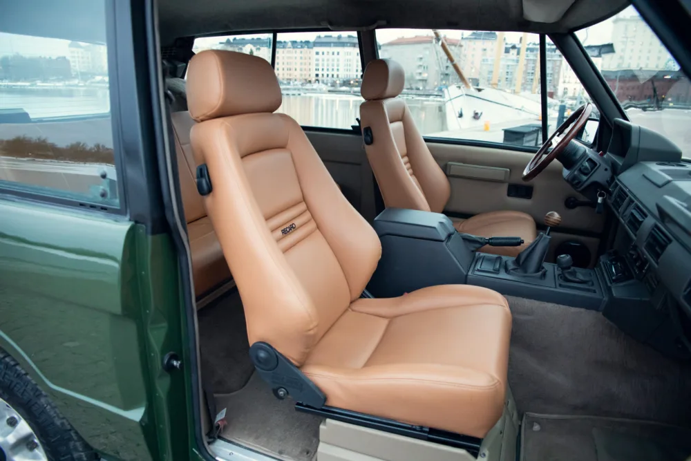 Beige leather car seats, vintage vehicle interior.