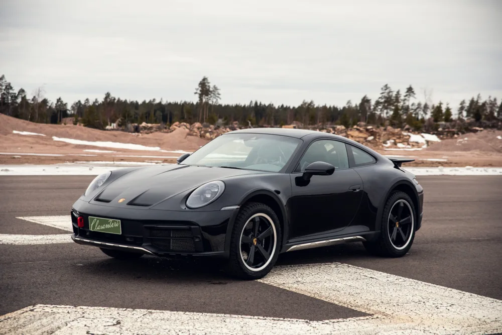 Black Porsche 911 on a deserted road