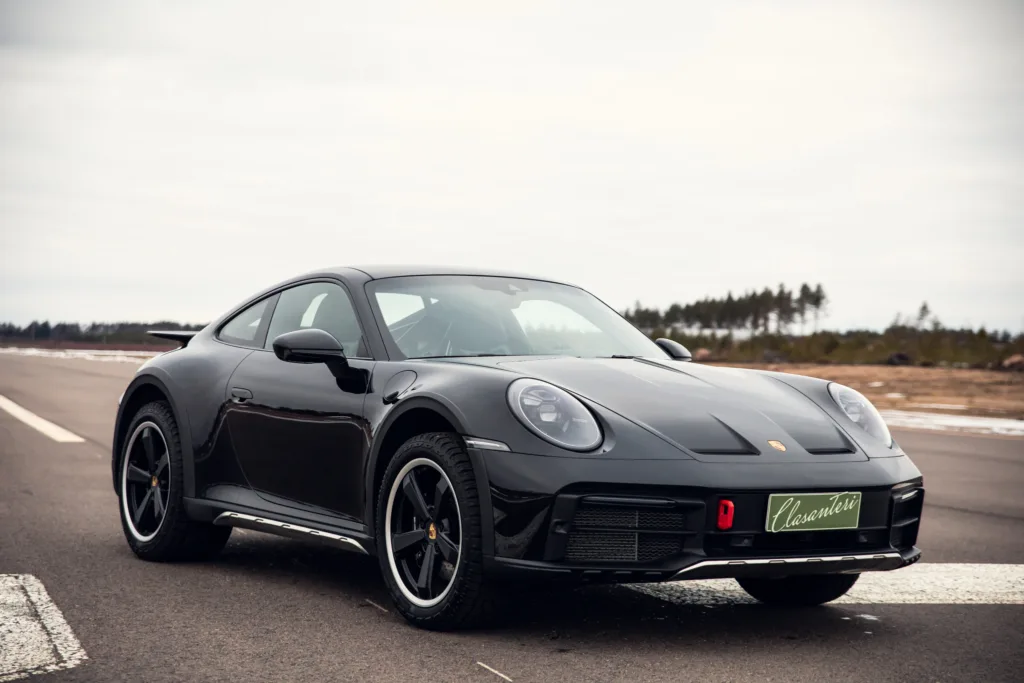 Black sports car on road.