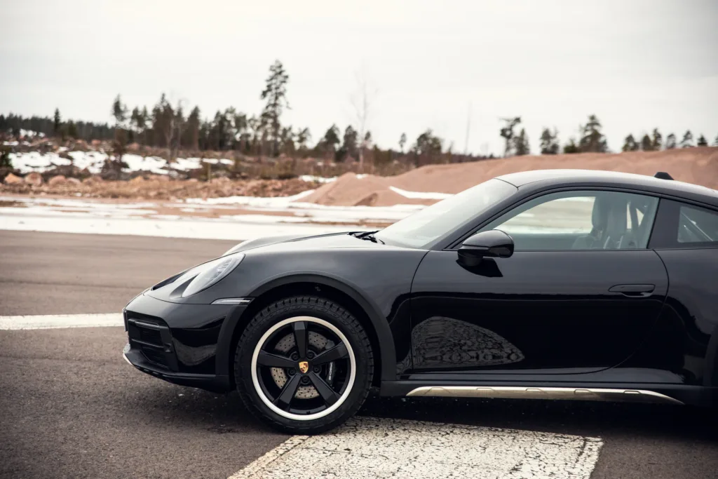 Black sports car parked on asphalt road