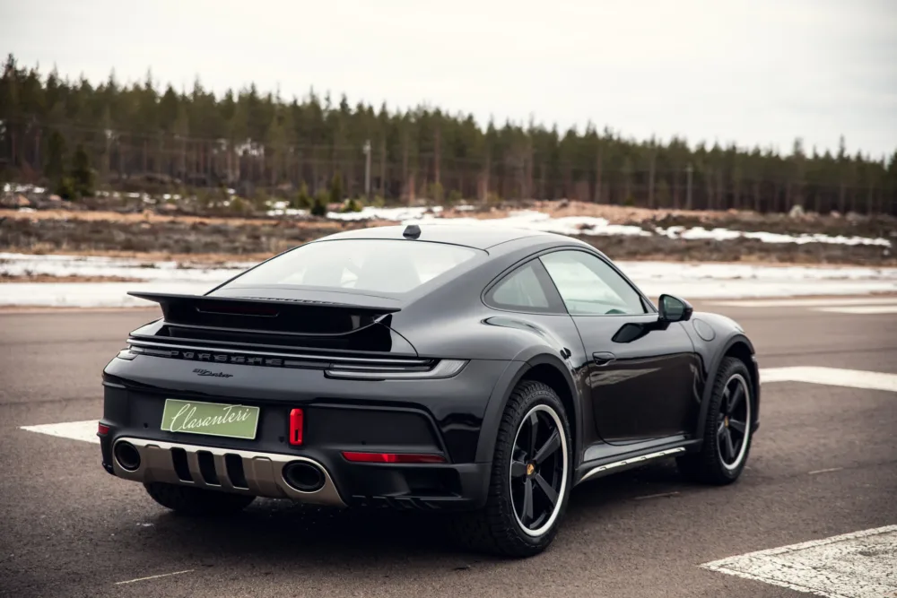Black Porsche 911 parked on roadside