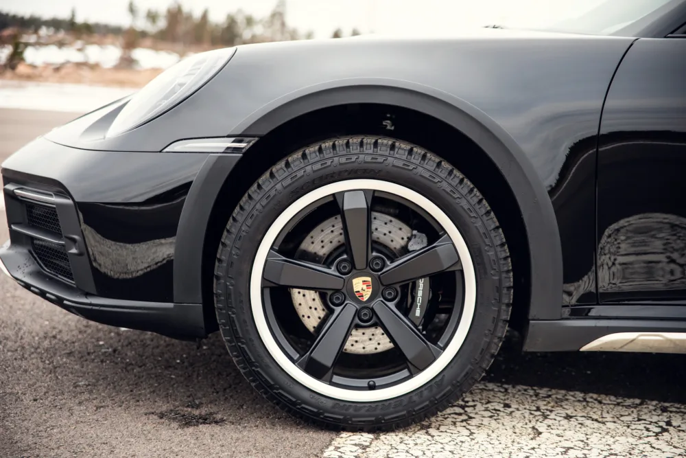 Black sports car wheel close-up.