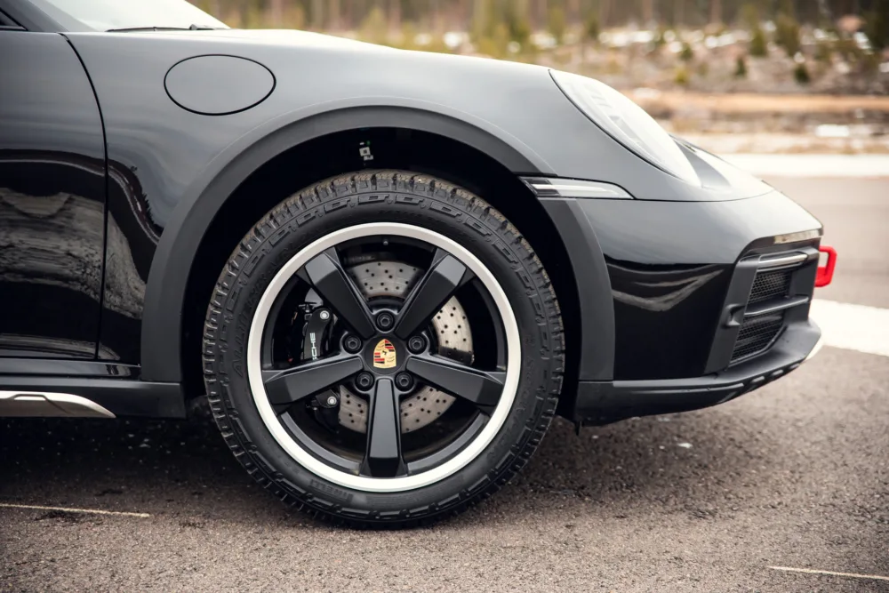 Black sports car wheel and brake detail.