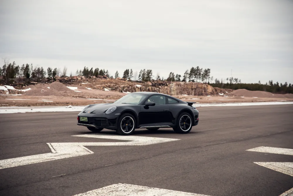 Black sports car on an empty airport runway