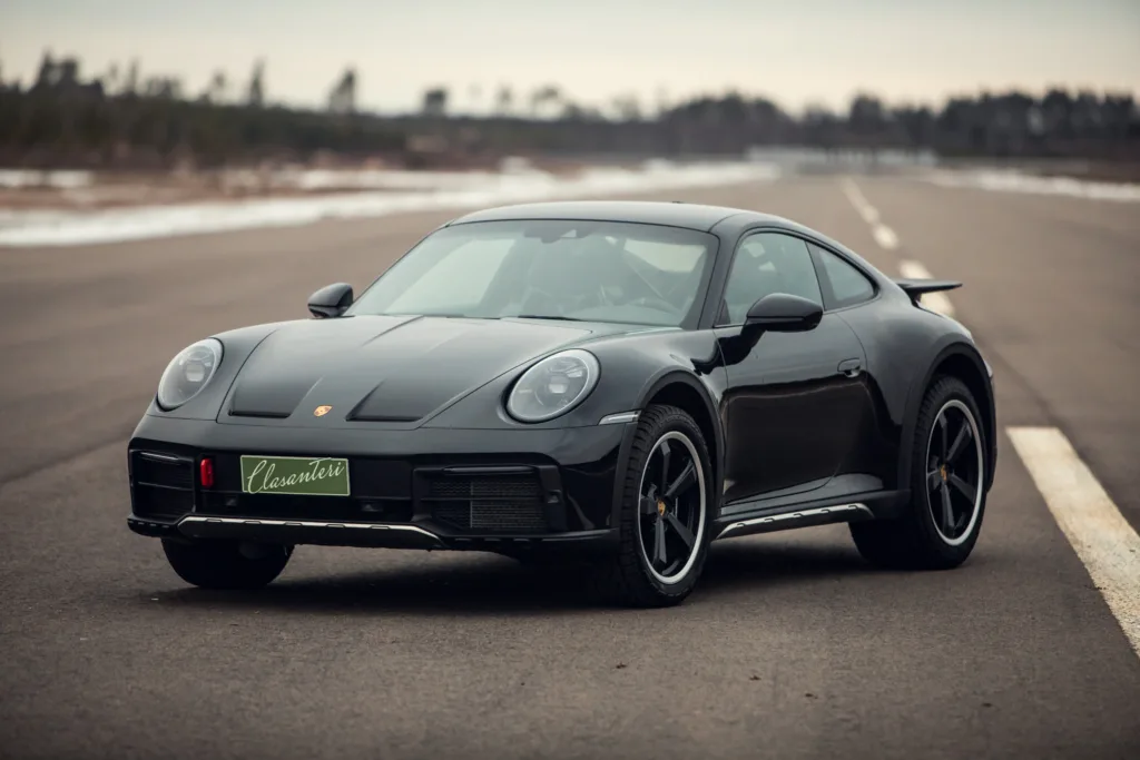 Black luxury sports car on empty road.