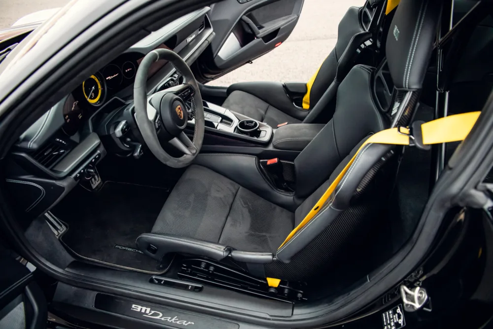Luxury car interior with yellow accents.
