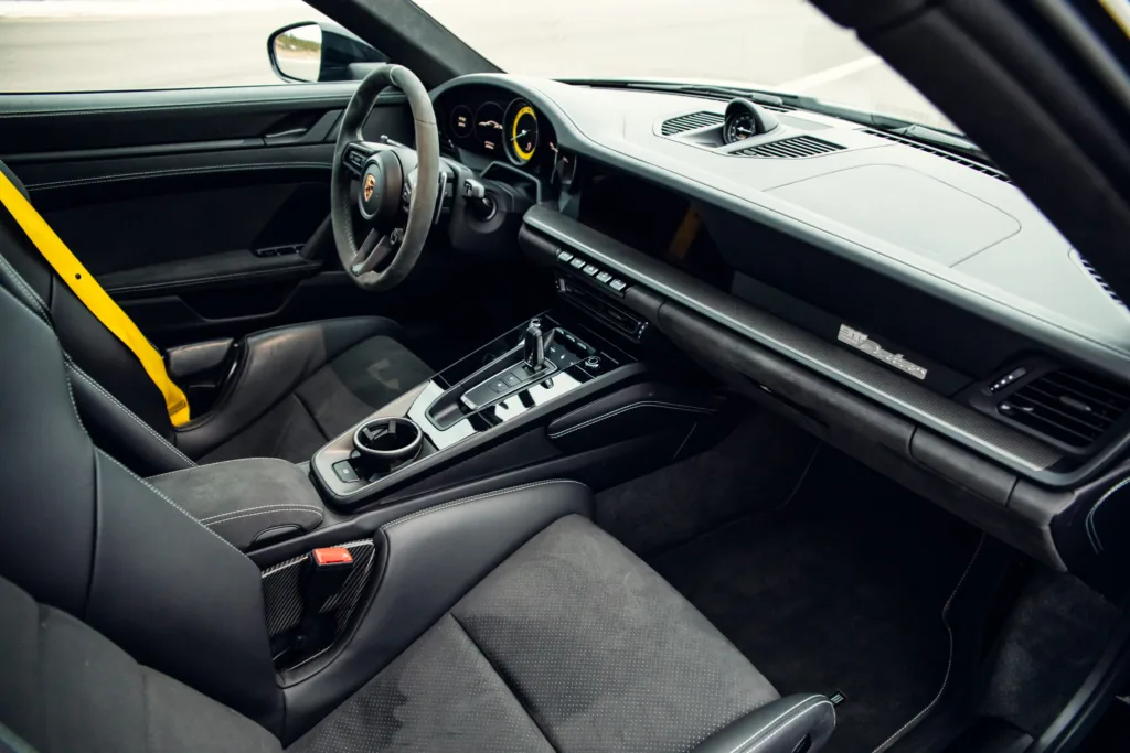 Luxury car interior design with yellow accents.