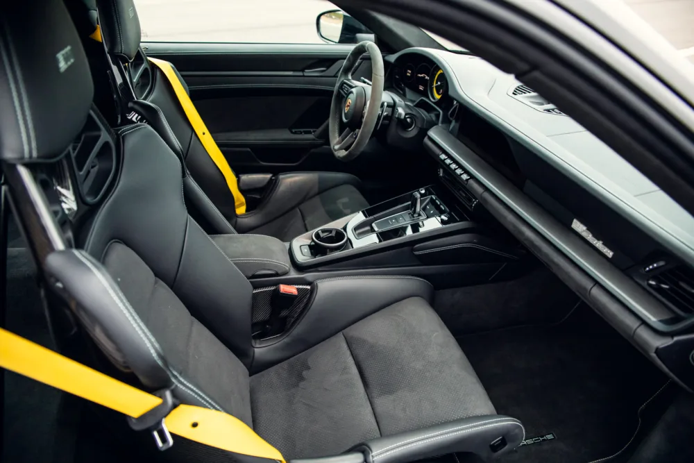 Luxury car interior with sporty design and yellow accents.