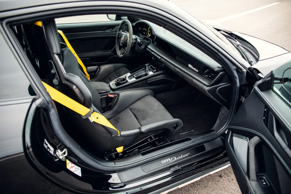 Sporty car interior with yellow accents.
