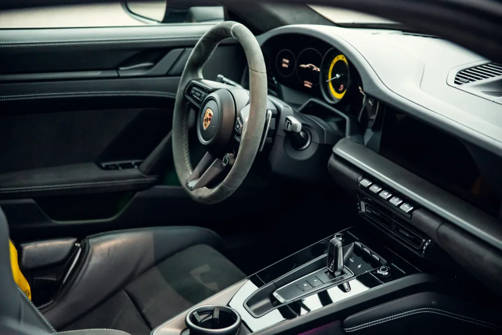 Luxury sports car interior with leather seats and dashboard.