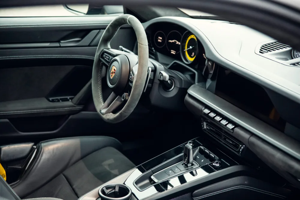 Luxury car interior, steering wheel, and dashboard.