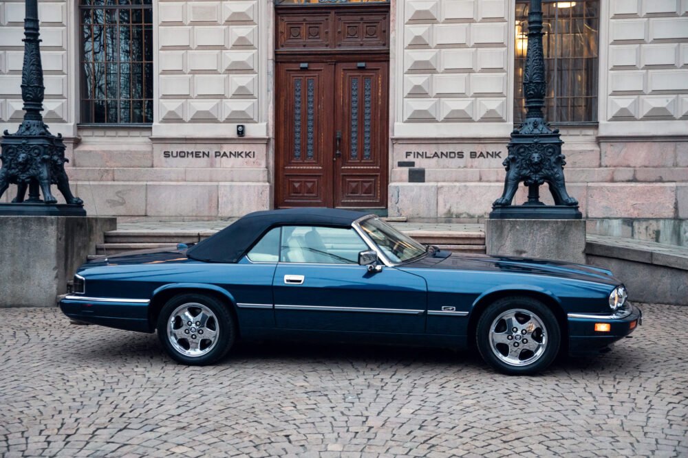 Blue classic car in front of Finland's Bank.