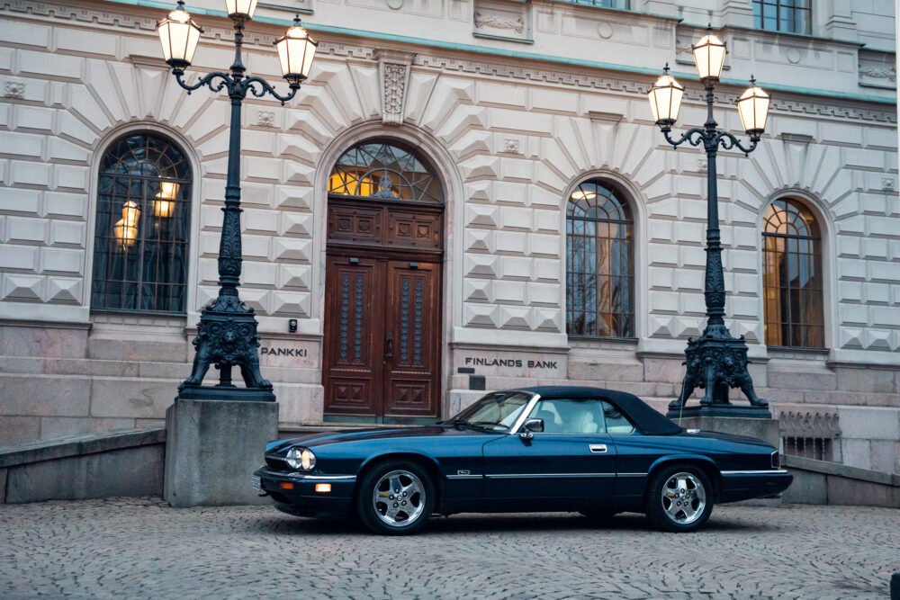 Vintage car parked in front of Finland's Bank building.