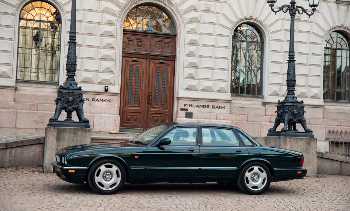 Green Jaguar car parked outside Finland's Bank.