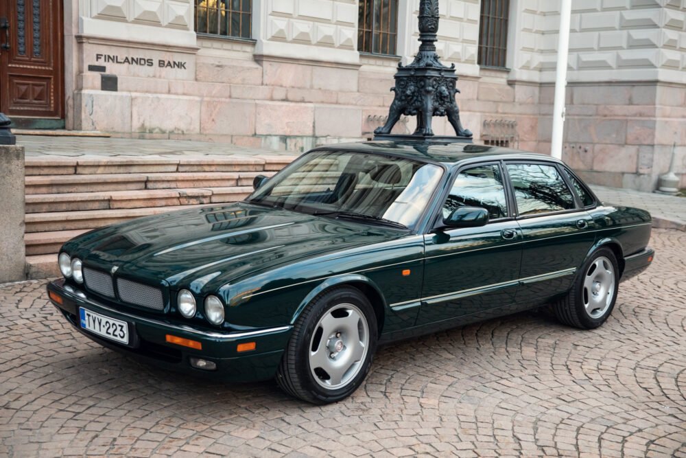 Green Jaguar car parked outside Bank of Finland.