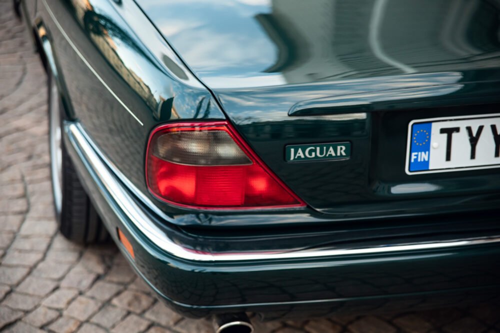 Close-up of Jaguar car's rear with Finnish license plate.