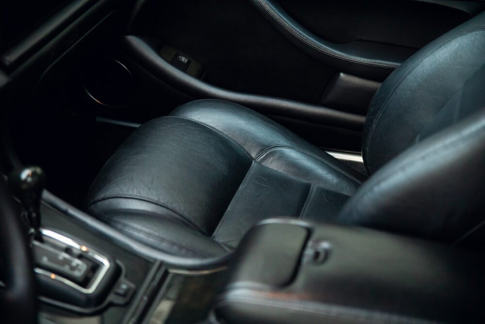 Black leather car interior, close-up view.