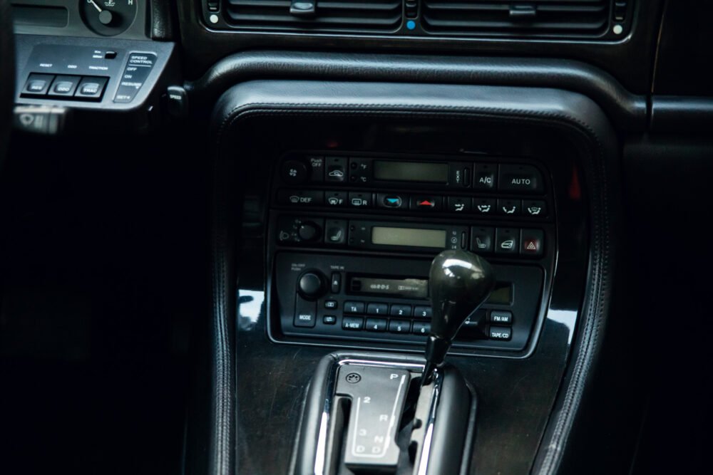 Car's interior showing dashboard and gear shifter.