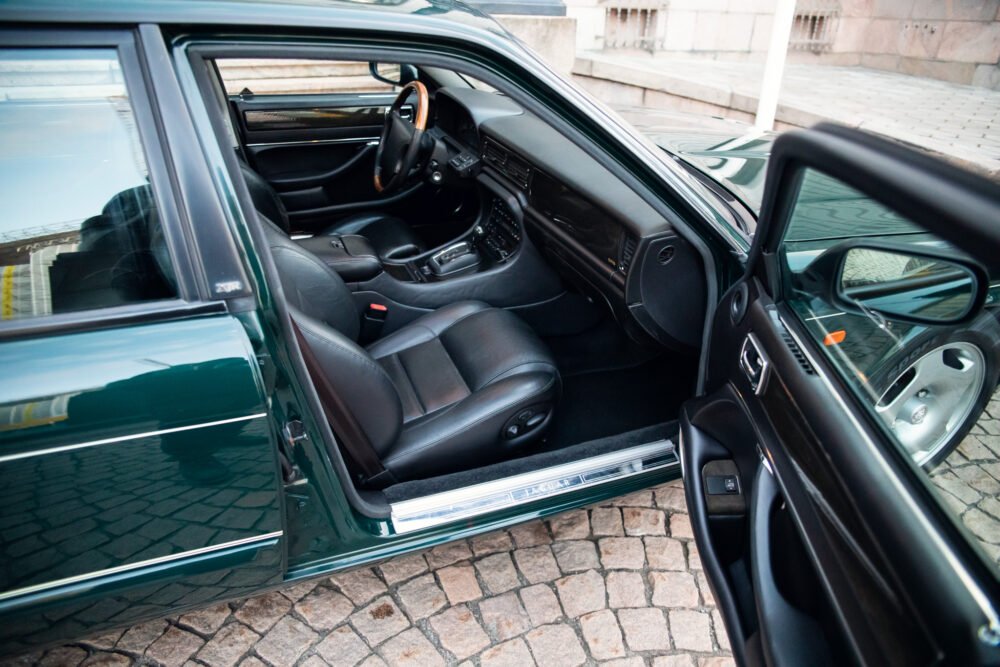 Luxury car interior with open door.