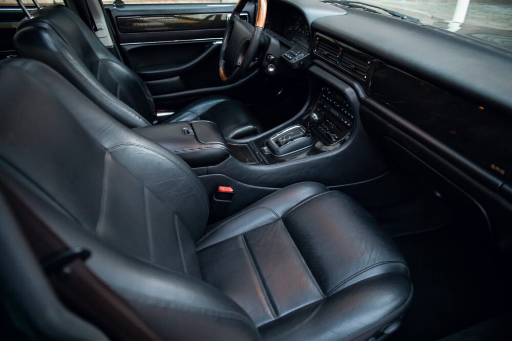 Luxury car interior with leather seats and dashboard.