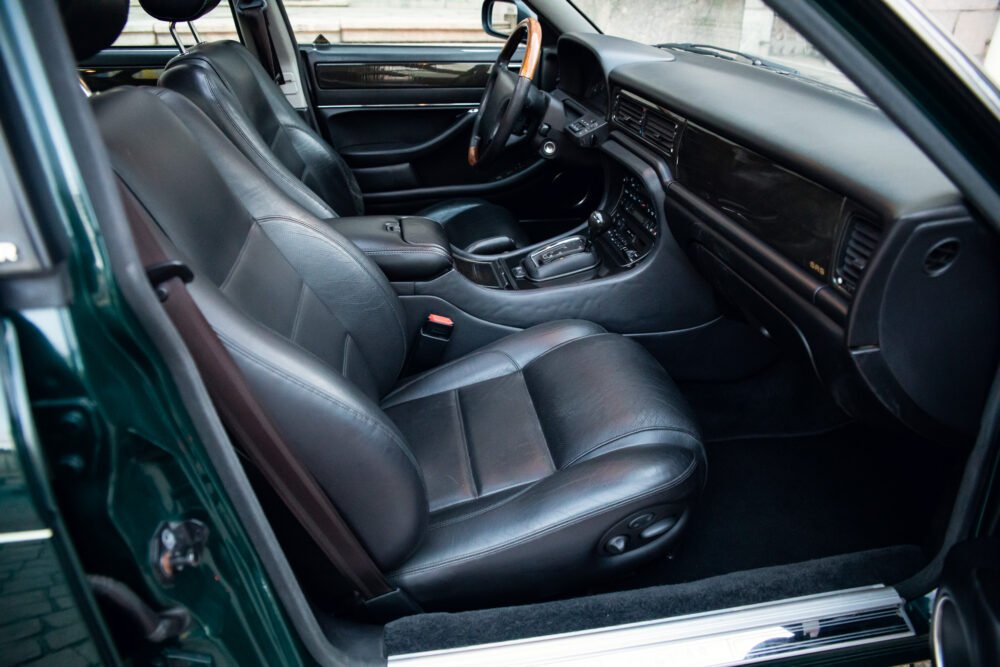 Luxury car interior with black leather seats and dashboard.