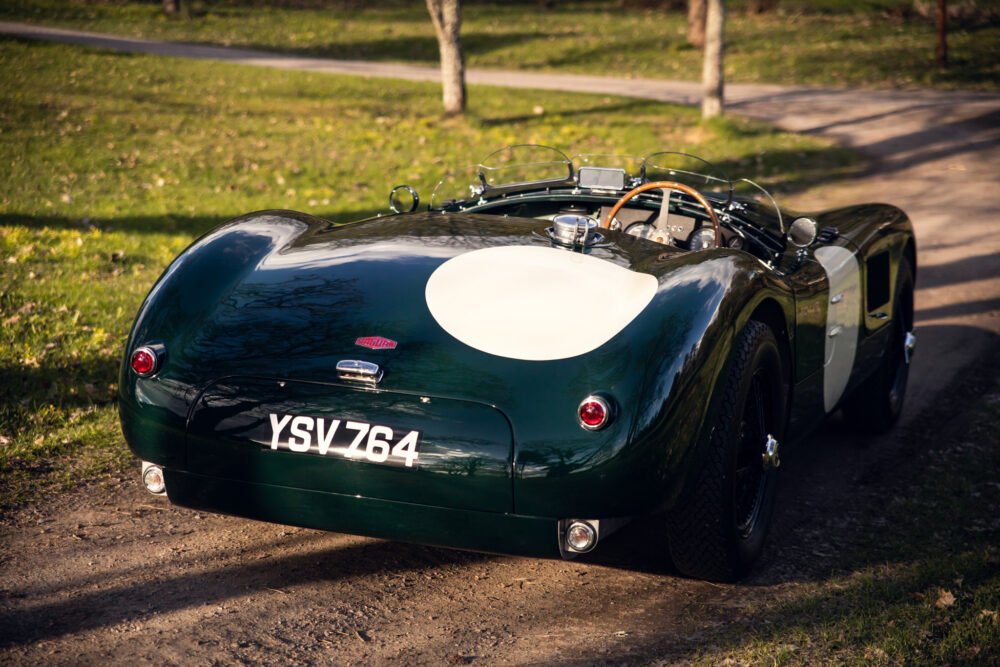 Vintage Jaguar sports car in park.