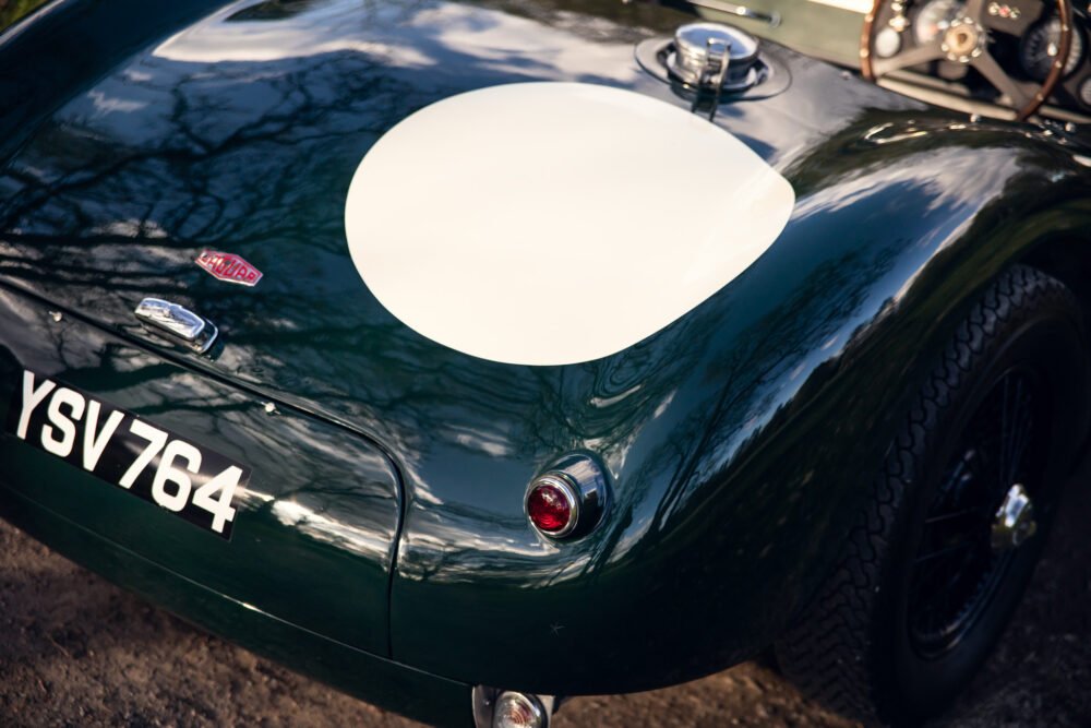 Vintage green sports car with racing number.