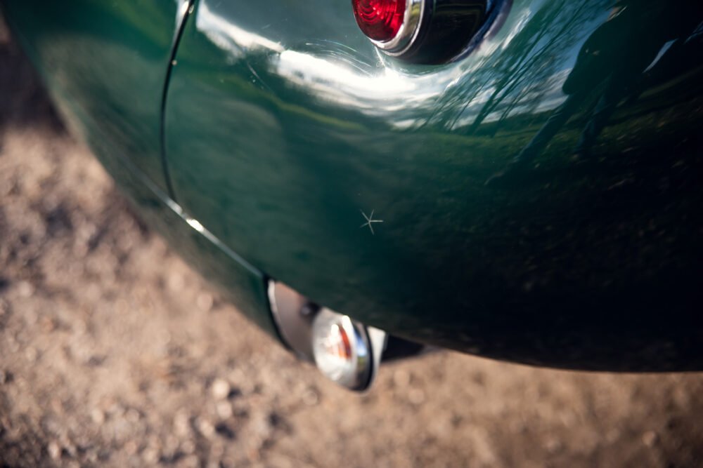Close-up of green vintage car's rear lights.