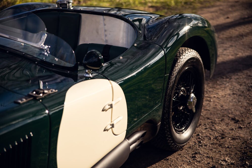 Vintage green sports car with detailed close-up.