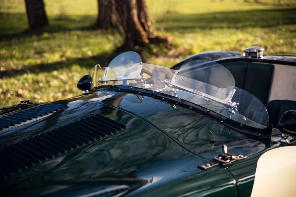 Classic car windshield in outdoor setting.