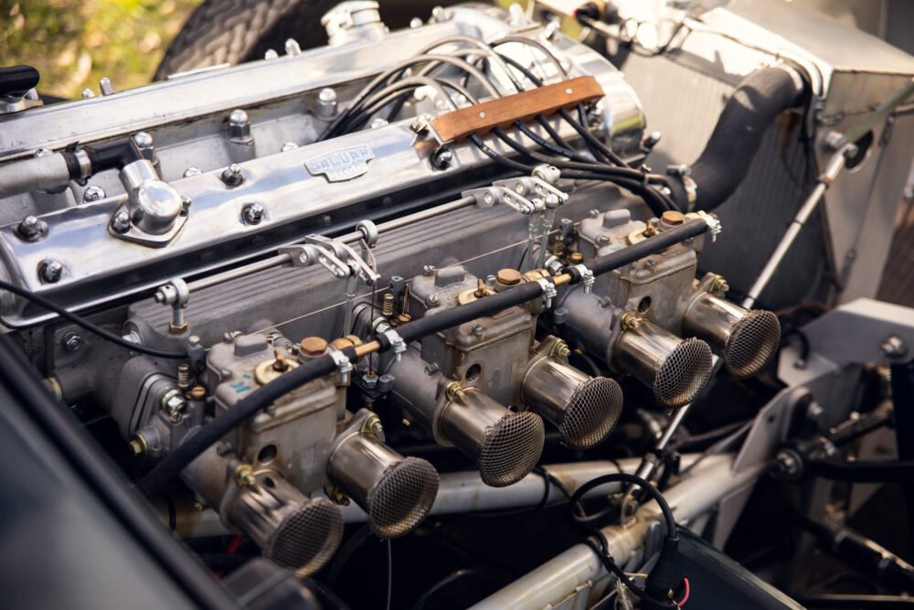 Detailed classic Jaguar car engine with visible components.