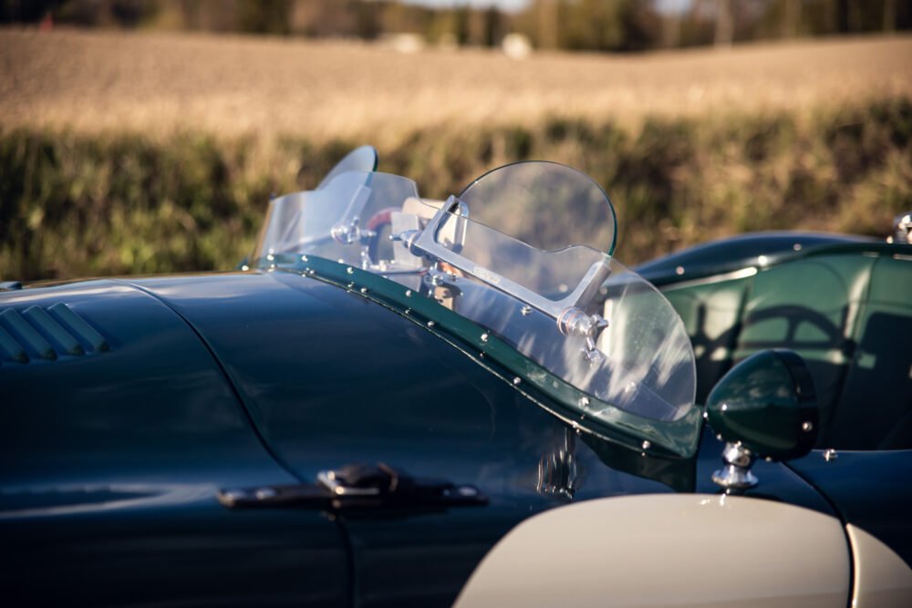Close-up of vintage car's shiny hood and windshield.