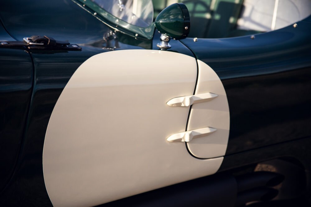 Close-up of vintage car's side panel and mirror.