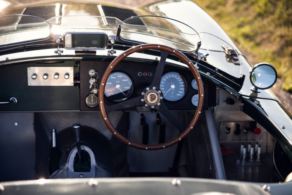Vintage car's steering wheel and dashboard close-up.