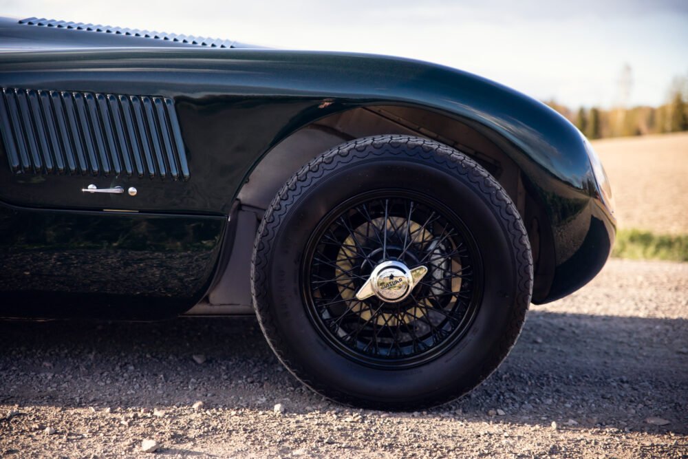 Close-up of classic car's wheel and fender.