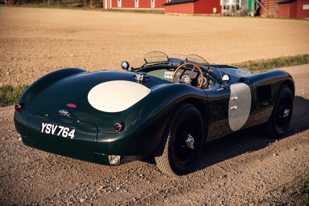 Vintage green sports car with racing number.