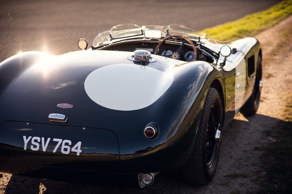 Vintage Jaguar sports car in sunlight.