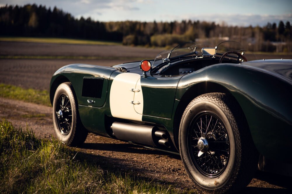 Vintage green sports car parked outdoors.