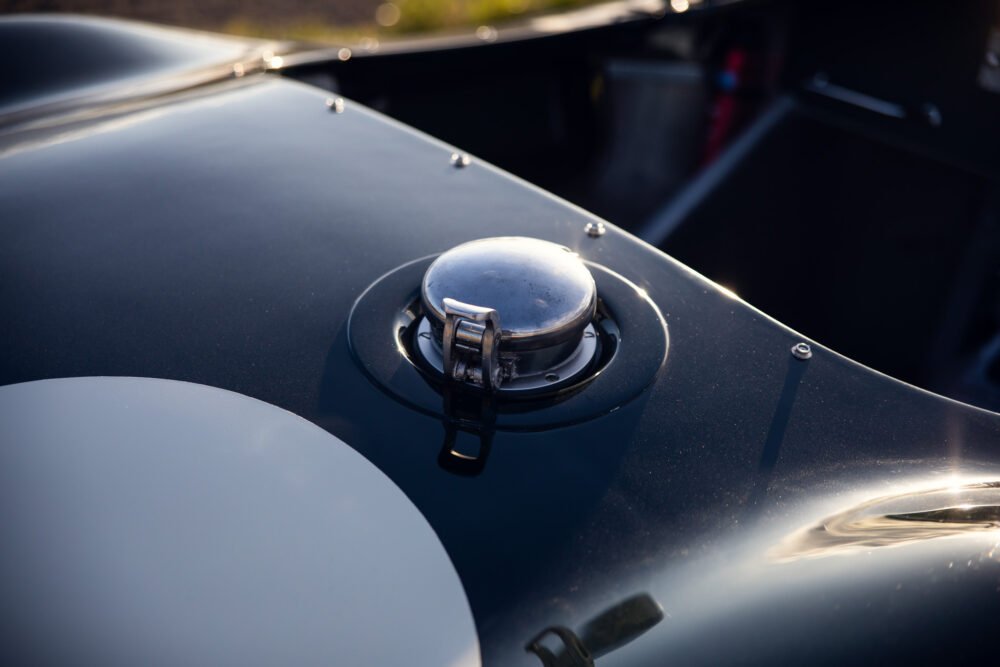 Close-up of vintage car fuel cap and hood.