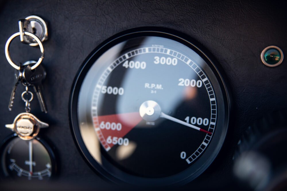 Close-up of car tachometer with keys attached.