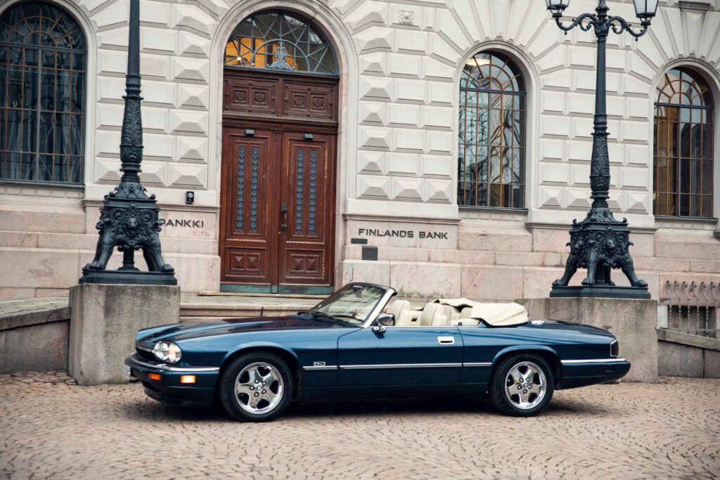 Vintage convertible car outside Finland's Bank building.
