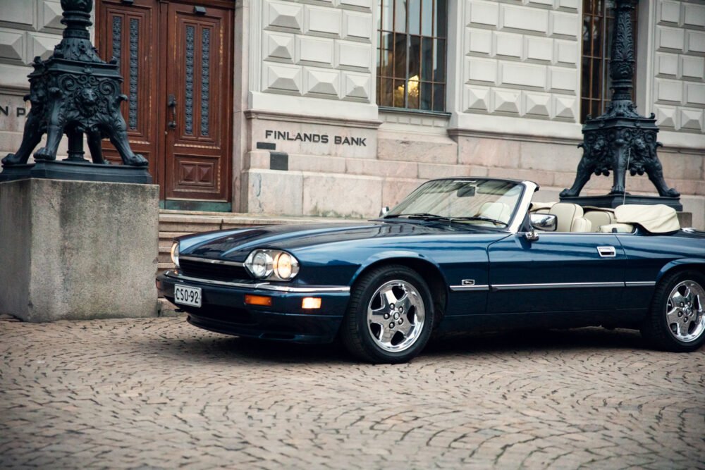 Vintage blue convertible in front of Finland's Bank.