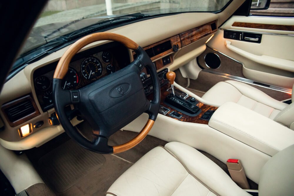 Luxurious car interior with wooden accents and leather seats.
