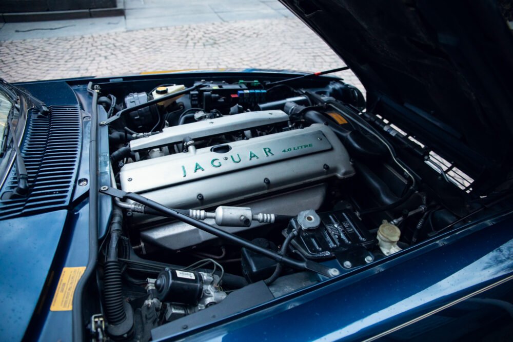 Jaguar car engine hood open, detailed view.