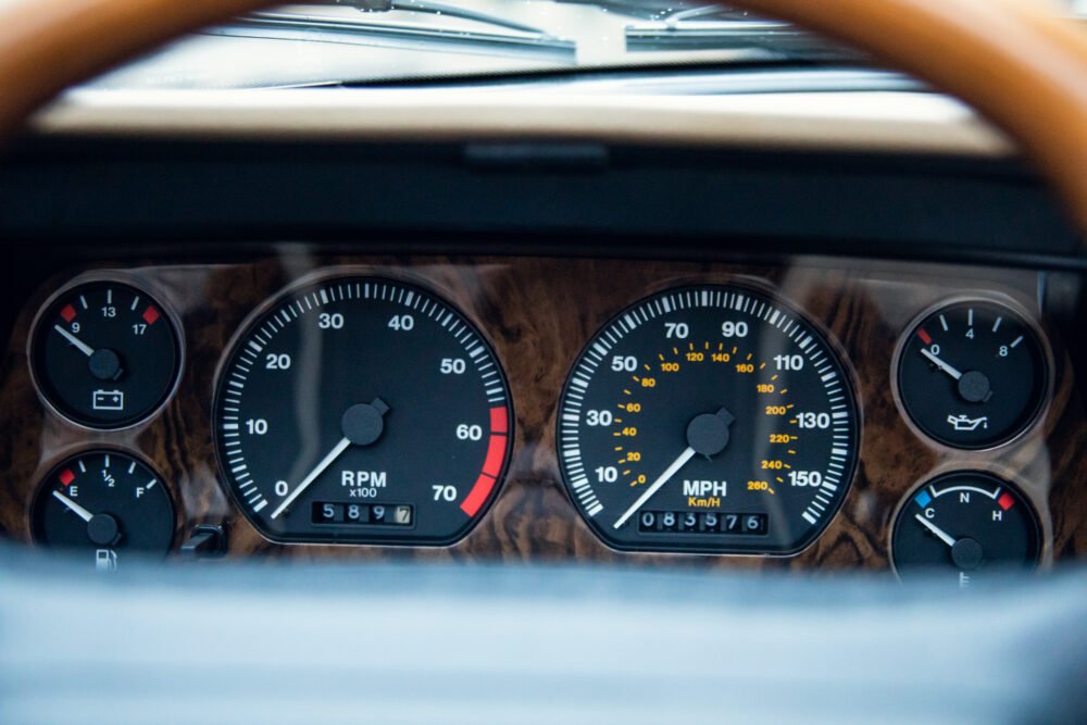 Classic car dashboard showing speedometer and gauges.