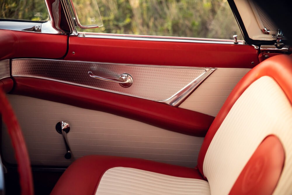 Vintage red car interior with chrome accents.
